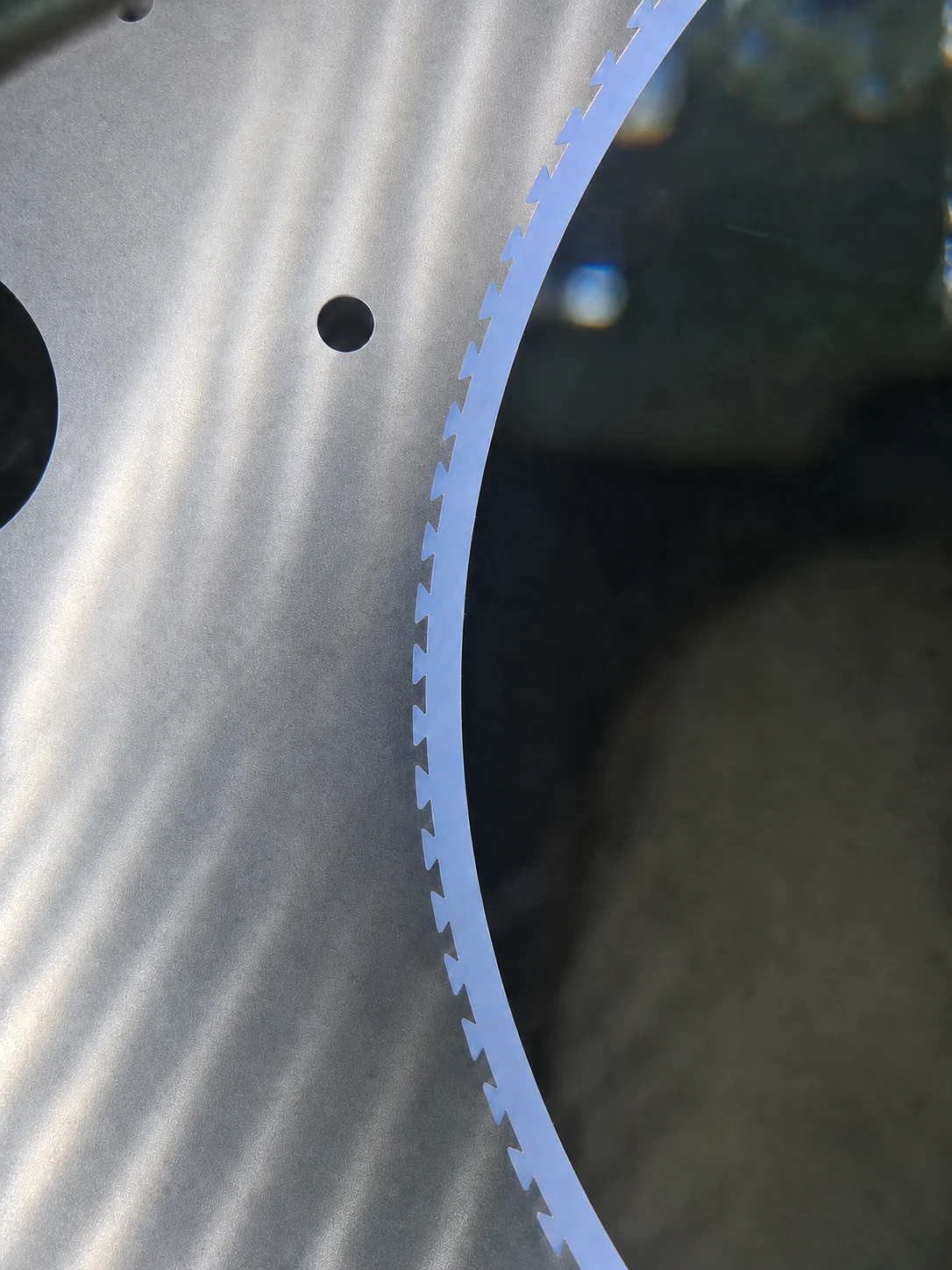 Clean close-up of a composite carrier metal body and polymer pocket insert