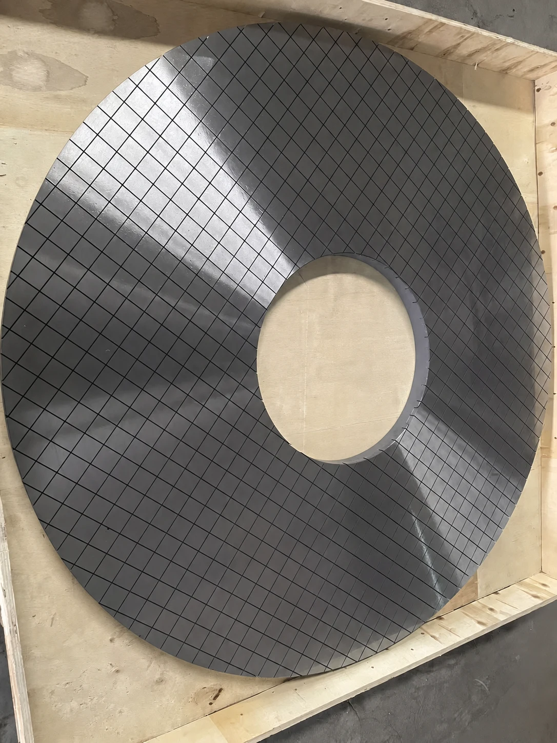 Real cross-grooved lapping plate photographed in a transport crate